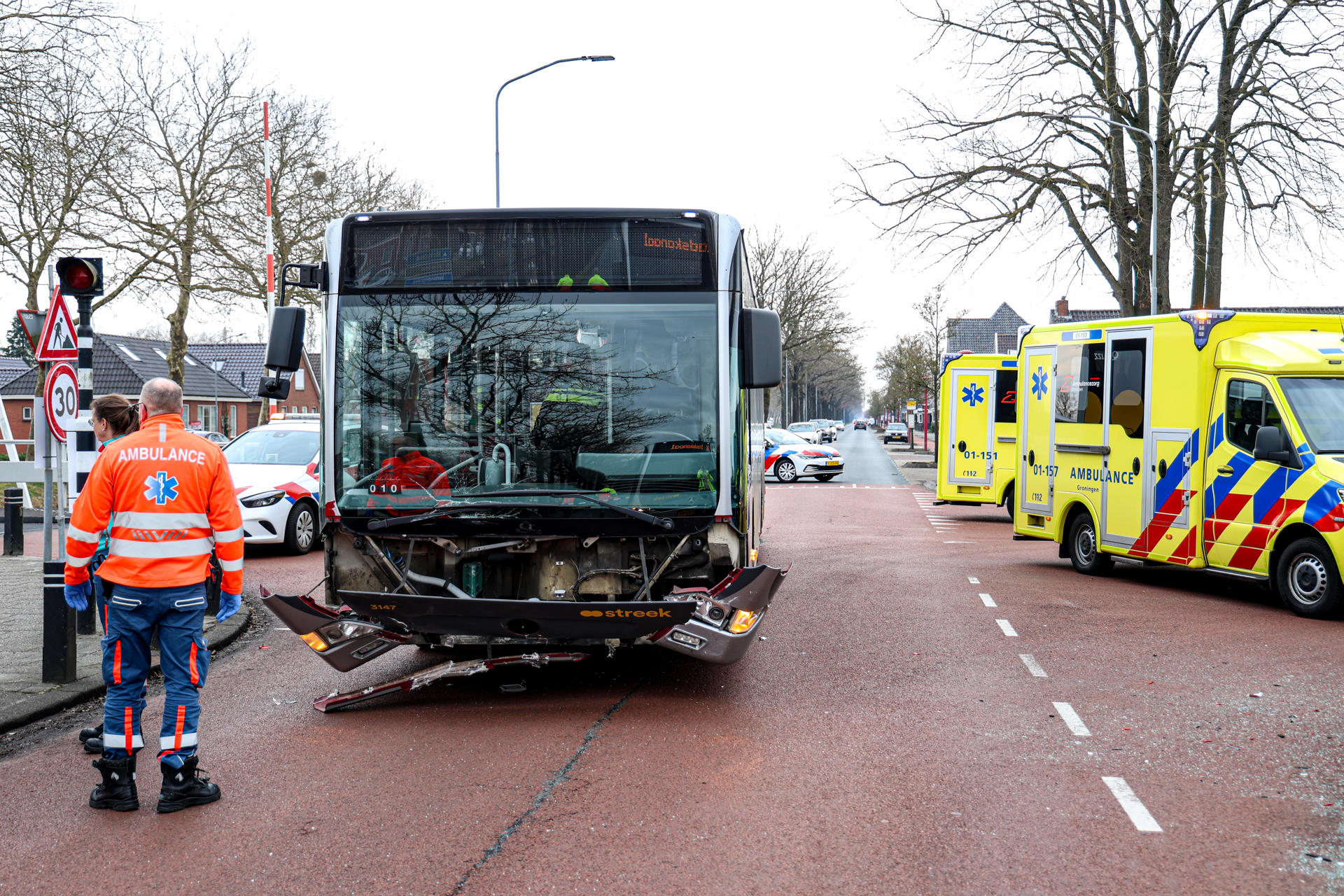Auto knalt tegen paal na botsing met lijnbus