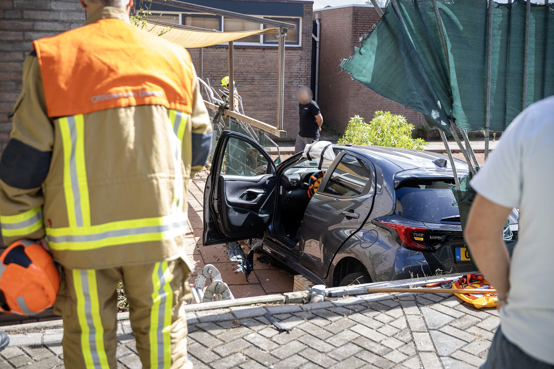 Auto rijdt door hekwerk en belandt op lagergelegen veld