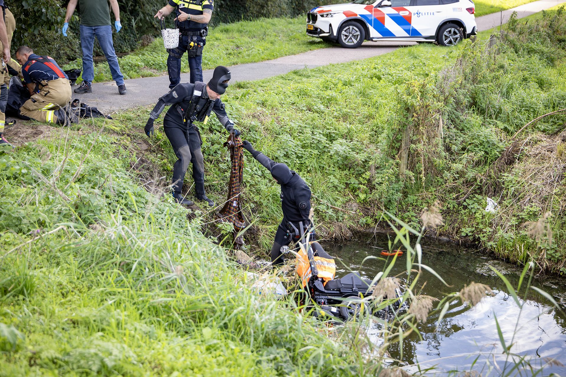Oudere man met scootmobiel te water in Haarlem